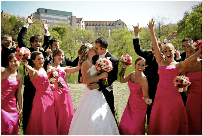 bride groom kiss with pink bridal party but expensive with people pleasing