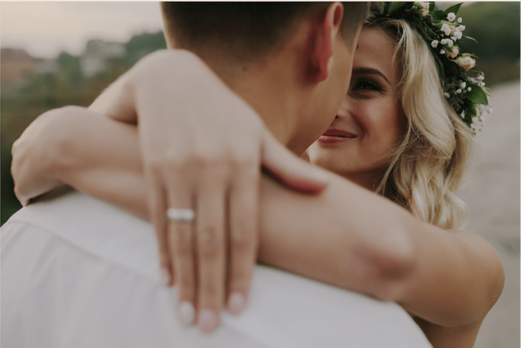 smiling bride with ring learning from money dates to build wealth beyond the wedding