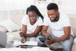 have a personal budget and wedding budget, couple sitting down for a budget 