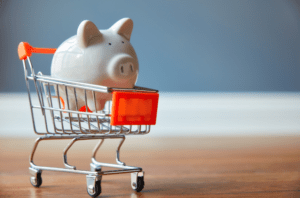 piggy bank in grocery cart ready to overspending