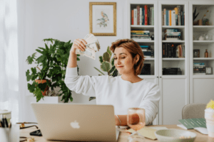 woman earning money with cash back on computer