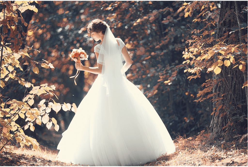 fall bride walking on a path