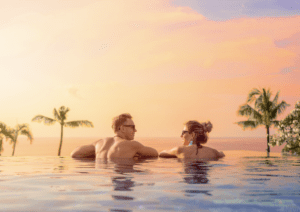 Couple in a pool planning how to fund a honeymoon 