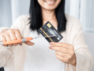 woman cutting up credit card 