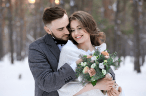 christmas bride and groom cuddling excited about holiday and registry gifts 