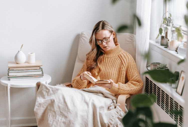 girl sitting with a book after her winter financial check in 