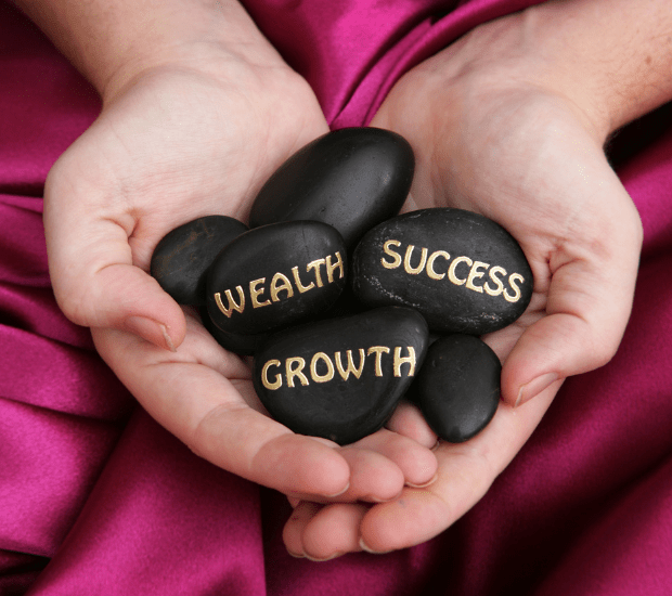 stones with wealth, success, and growth on them 